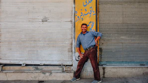 A happy customer standing next to a newly customized maritime container with a bright smile