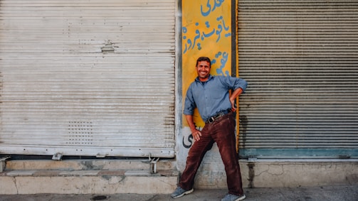 Friendly local handyman and painter smiling while working on a home exterior in Tenerife.