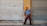 A satisfied customer standing in front of a freshly painted building.