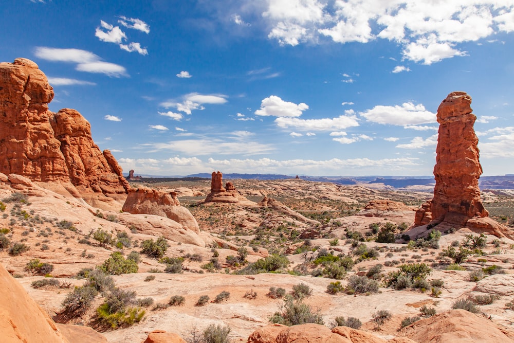 brown rock formation under blue sky and white clouds during daytime