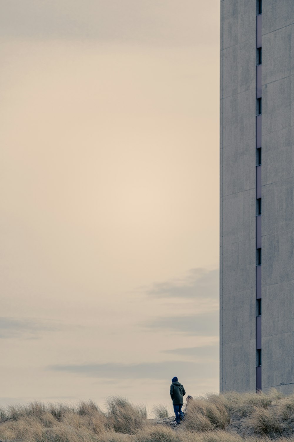 gray concrete building under white clouds during daytime