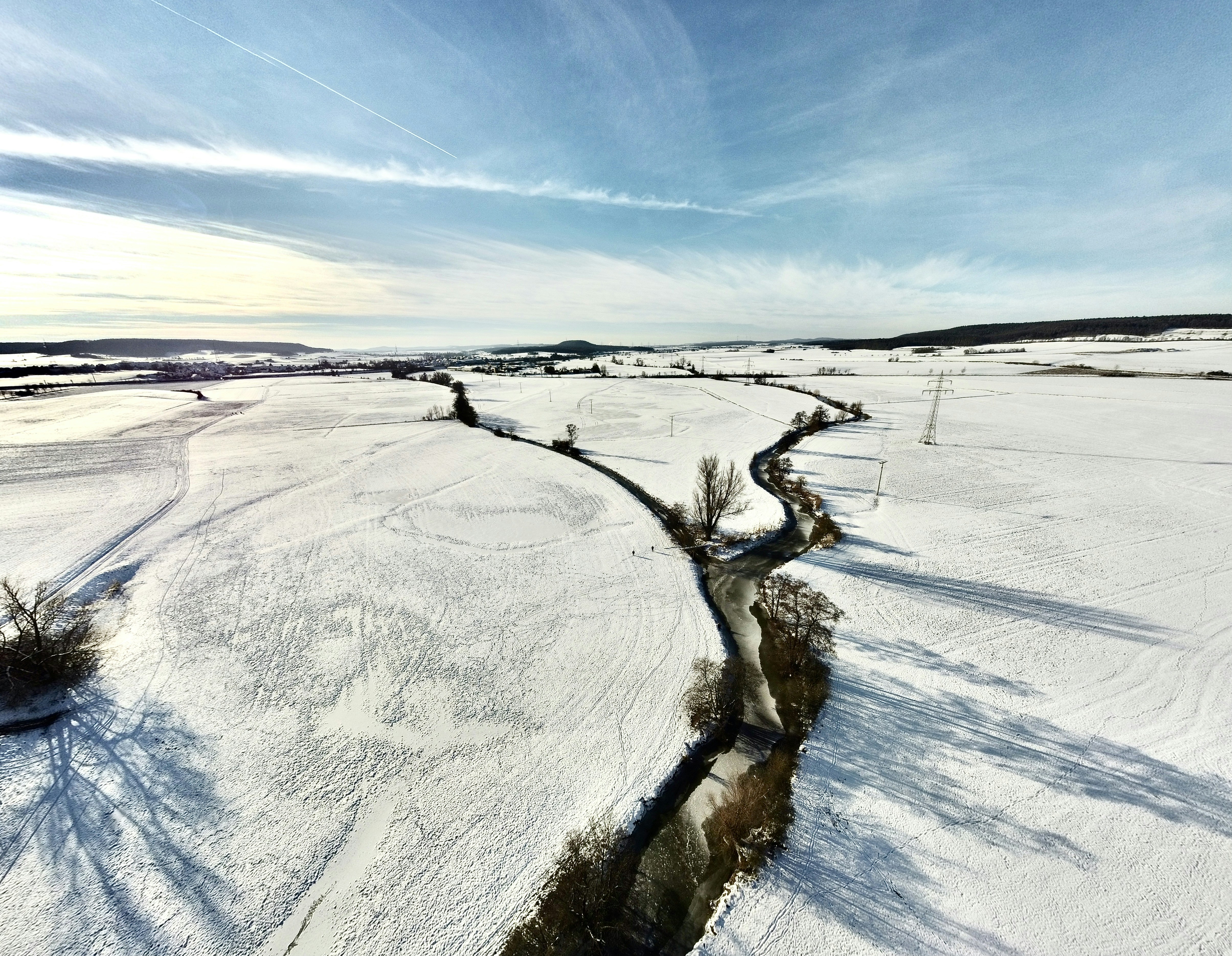 white snow covered field under blue sky during daytime