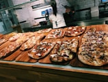 A selection of pizzas ready for takeout.