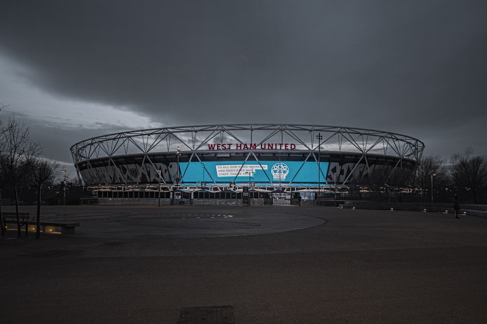 red and blue bridge under gray sky