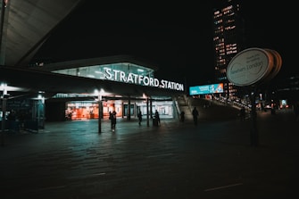 people walking on sidewalk during night time