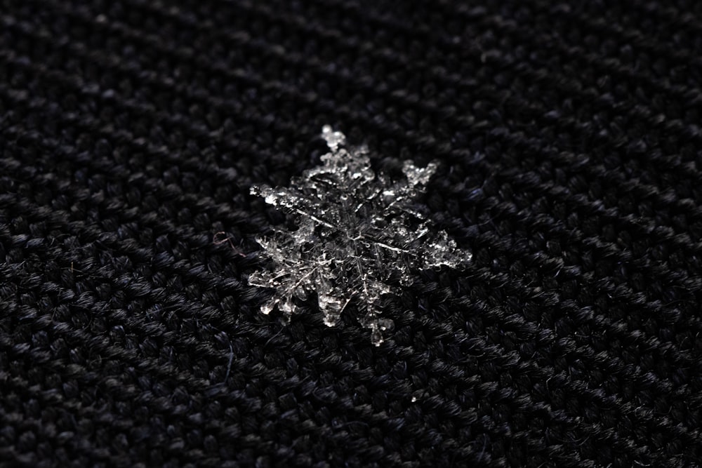 black and white snow flakes on blue textile