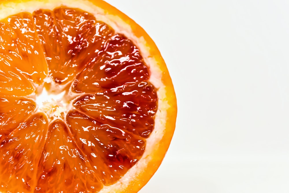 sliced orange fruit on white surface