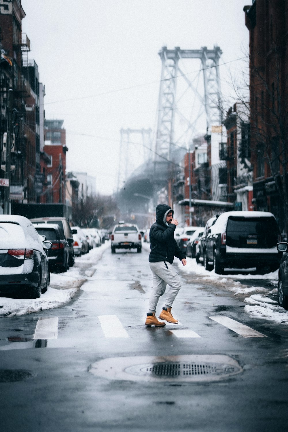 man in black jacket and black pants walking on street during daytime