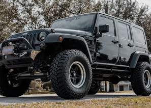 black jeep wrangler on road during daytime