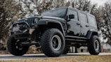 black jeep wrangler on road during daytime