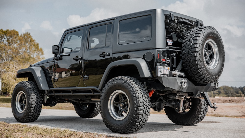 black jeep wrangler on road during daytime