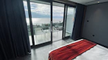 Spacious bedroom with crisp white linens and a large window framing the sea.