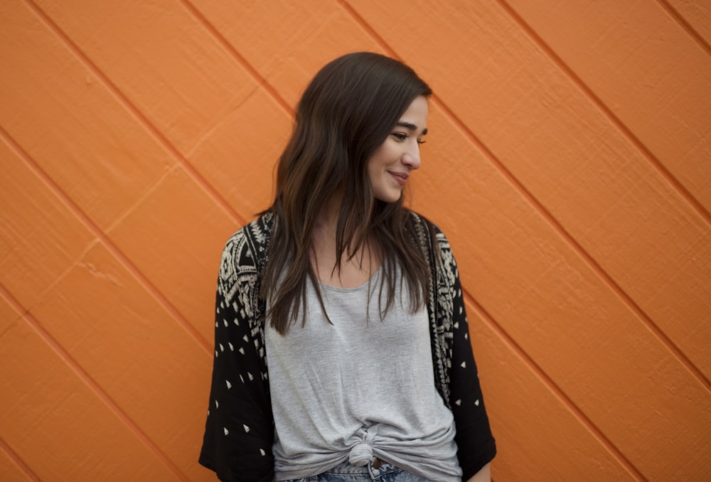 woman in black and white polka dot long sleeve shirt and gray denim jeans