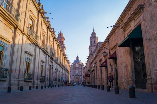 People walking on street between buildings during daytime — Morelia, Mexico