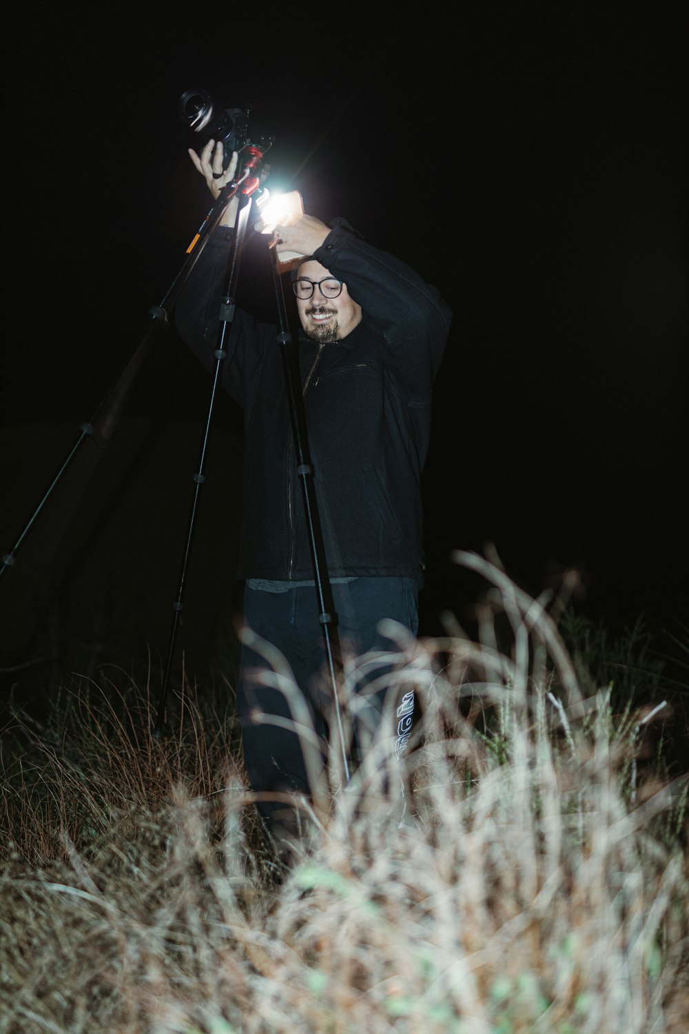 person in black jacket holding lighted sparkler