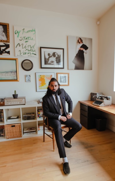 man in black jacket sitting on chair
