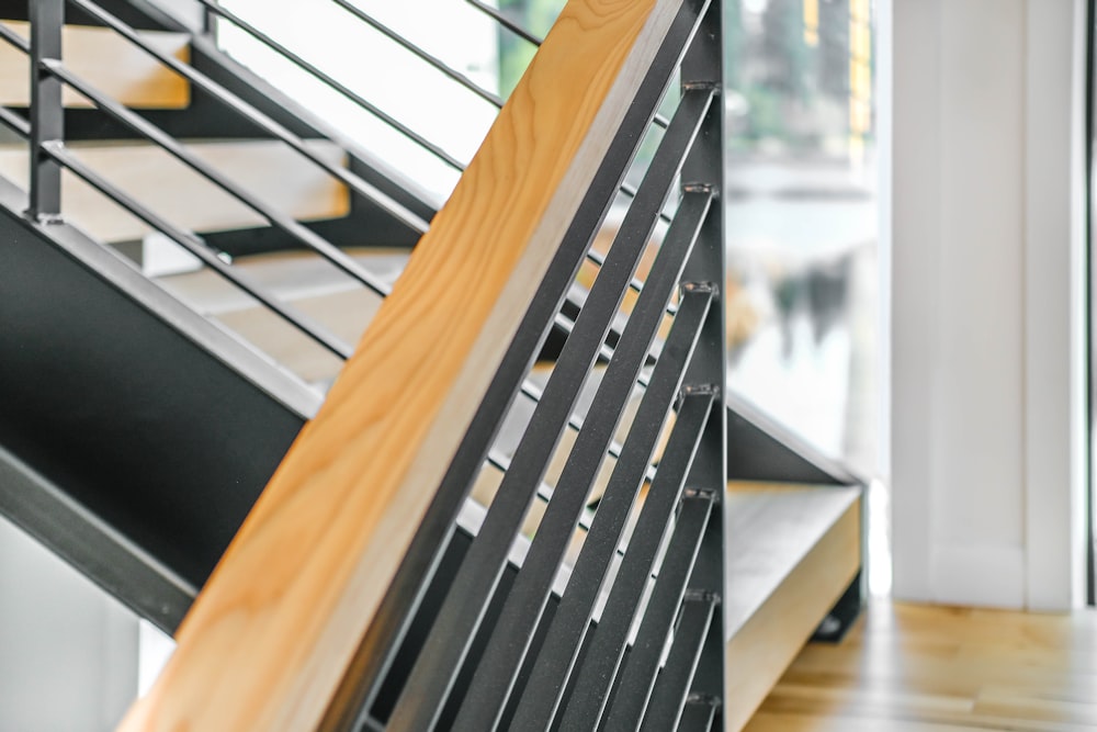 brown wooden staircase near window