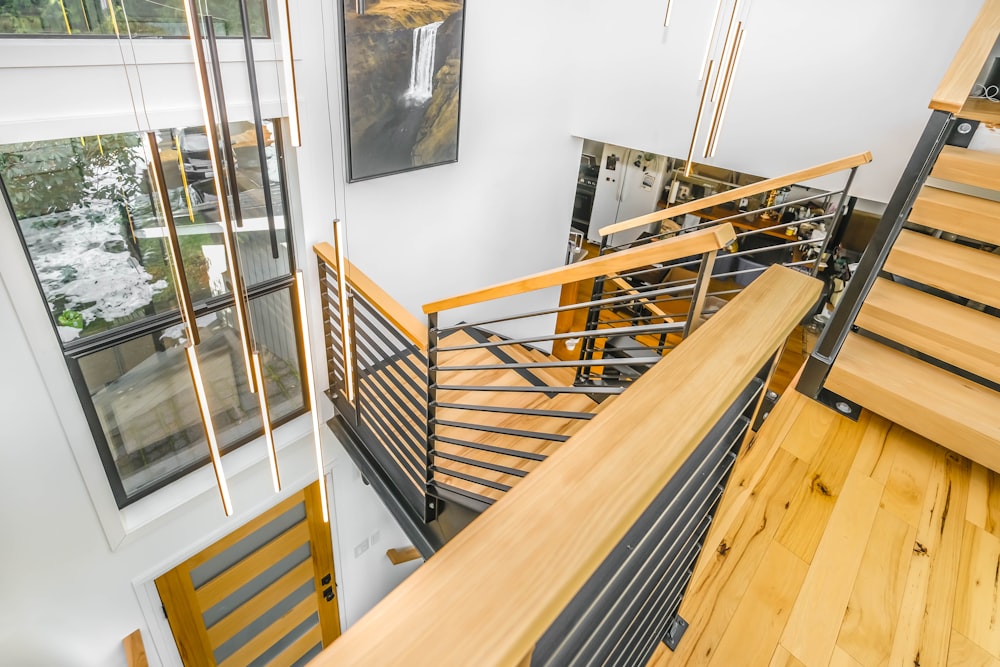 brown wooden staircase near white wall