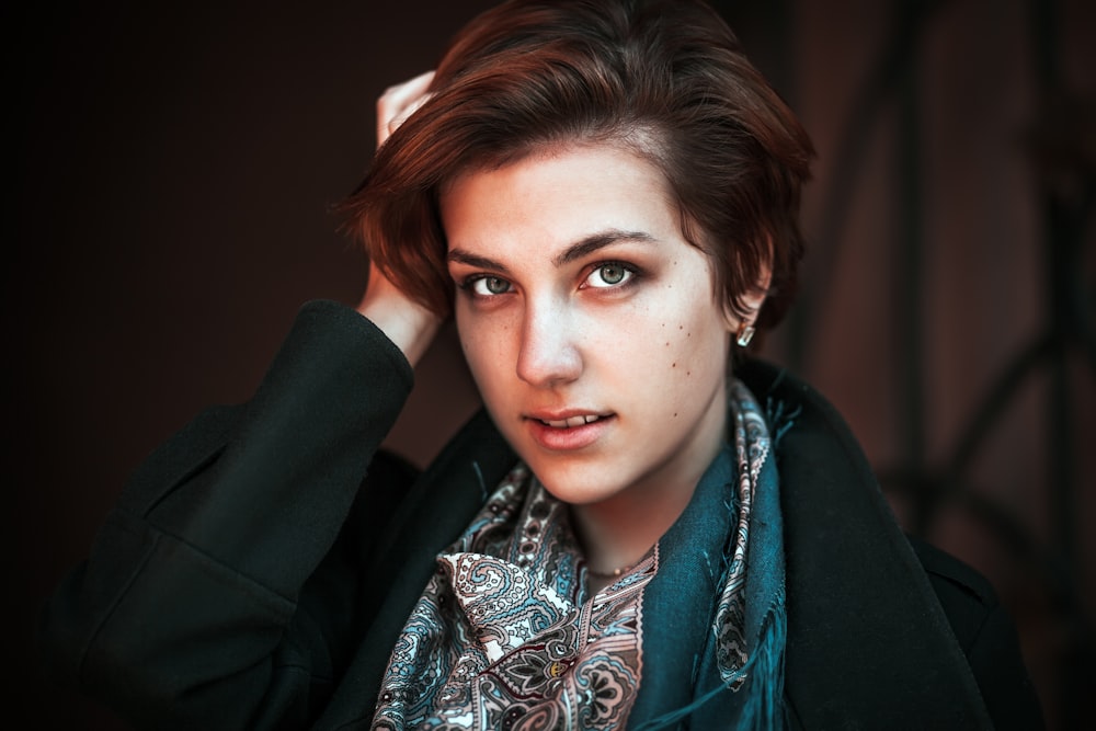 woman in black blazer and gray and white scarf