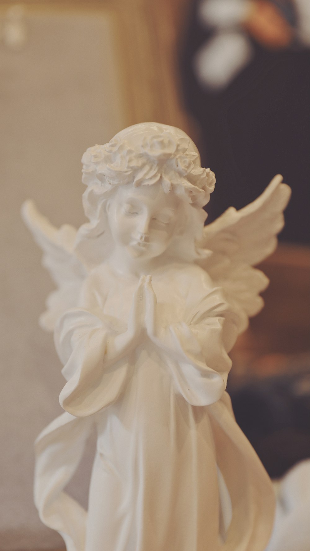 white angel ceramic figurine on black surface