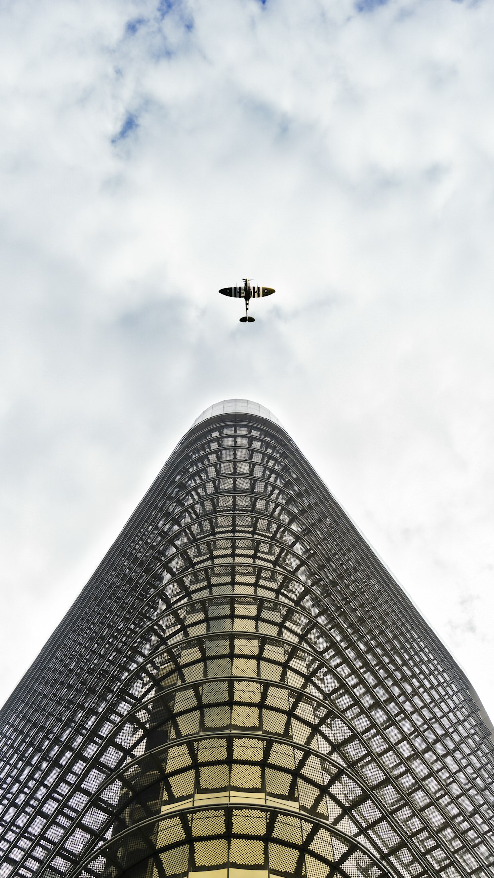 airplane flying over the building