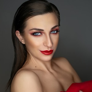 woman in red lipstick and black mascara