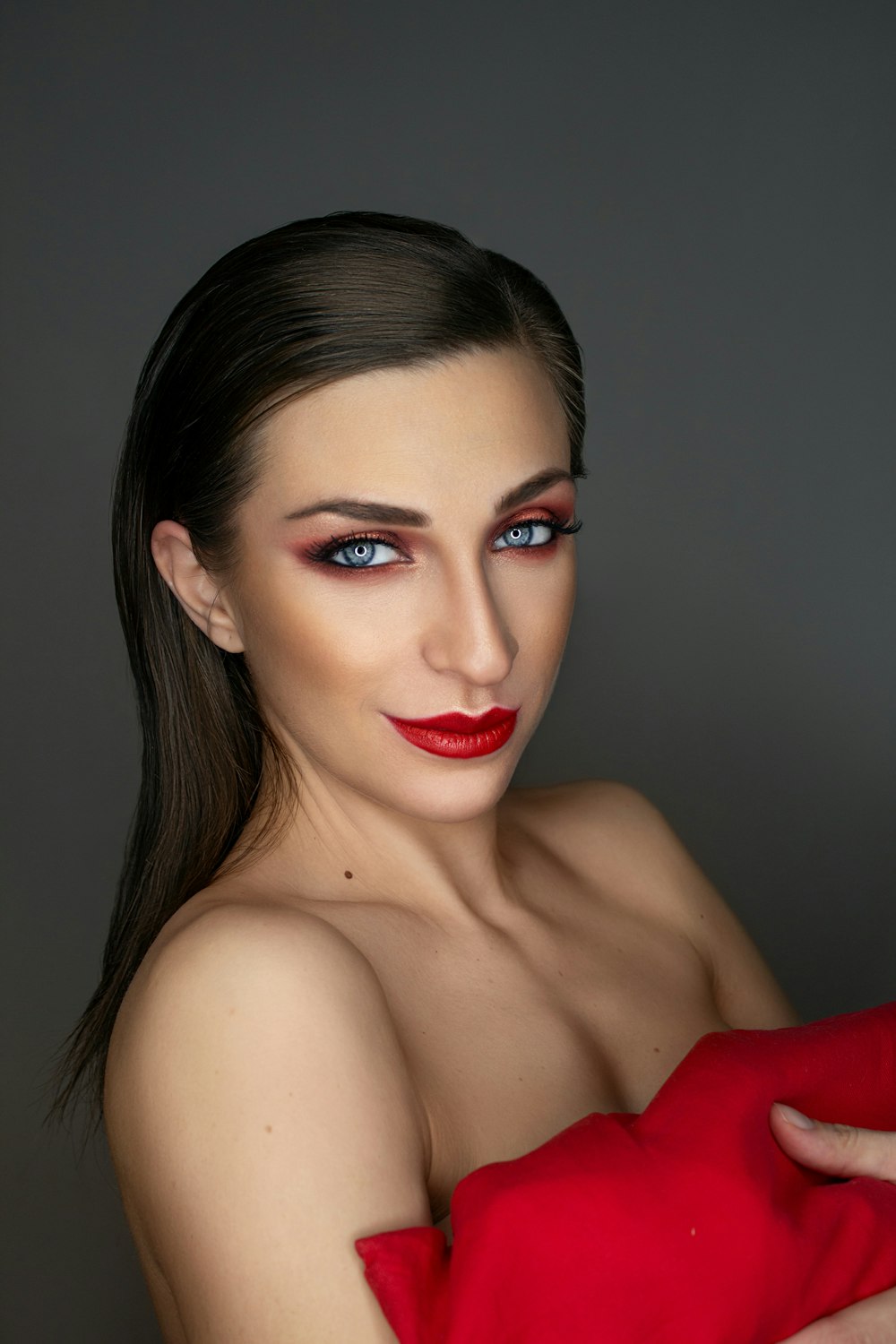 woman in red lipstick and black mascara