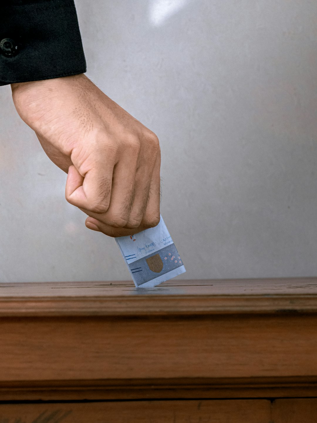 person holding white and blue soft tube