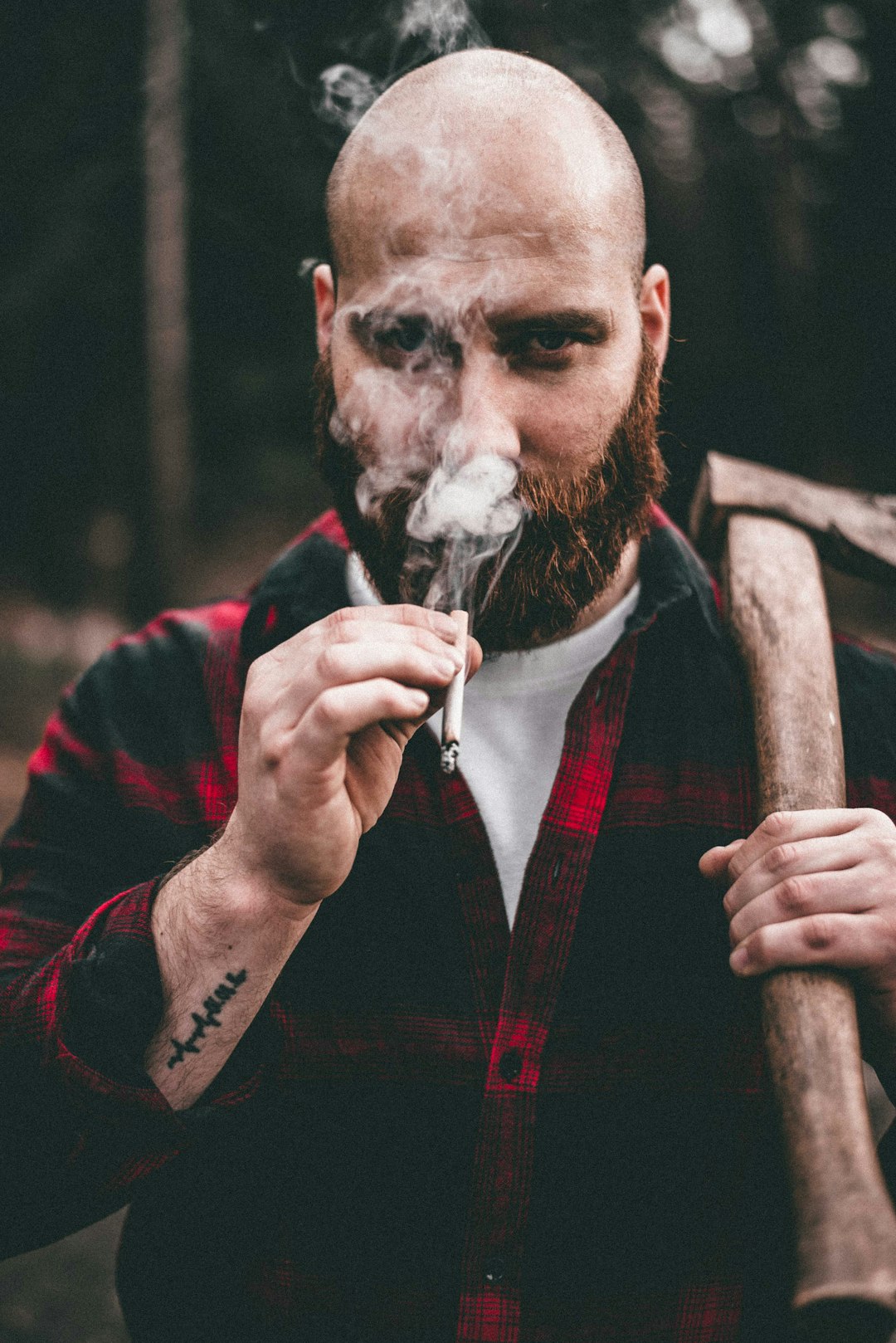 man in red and black jacket smoking