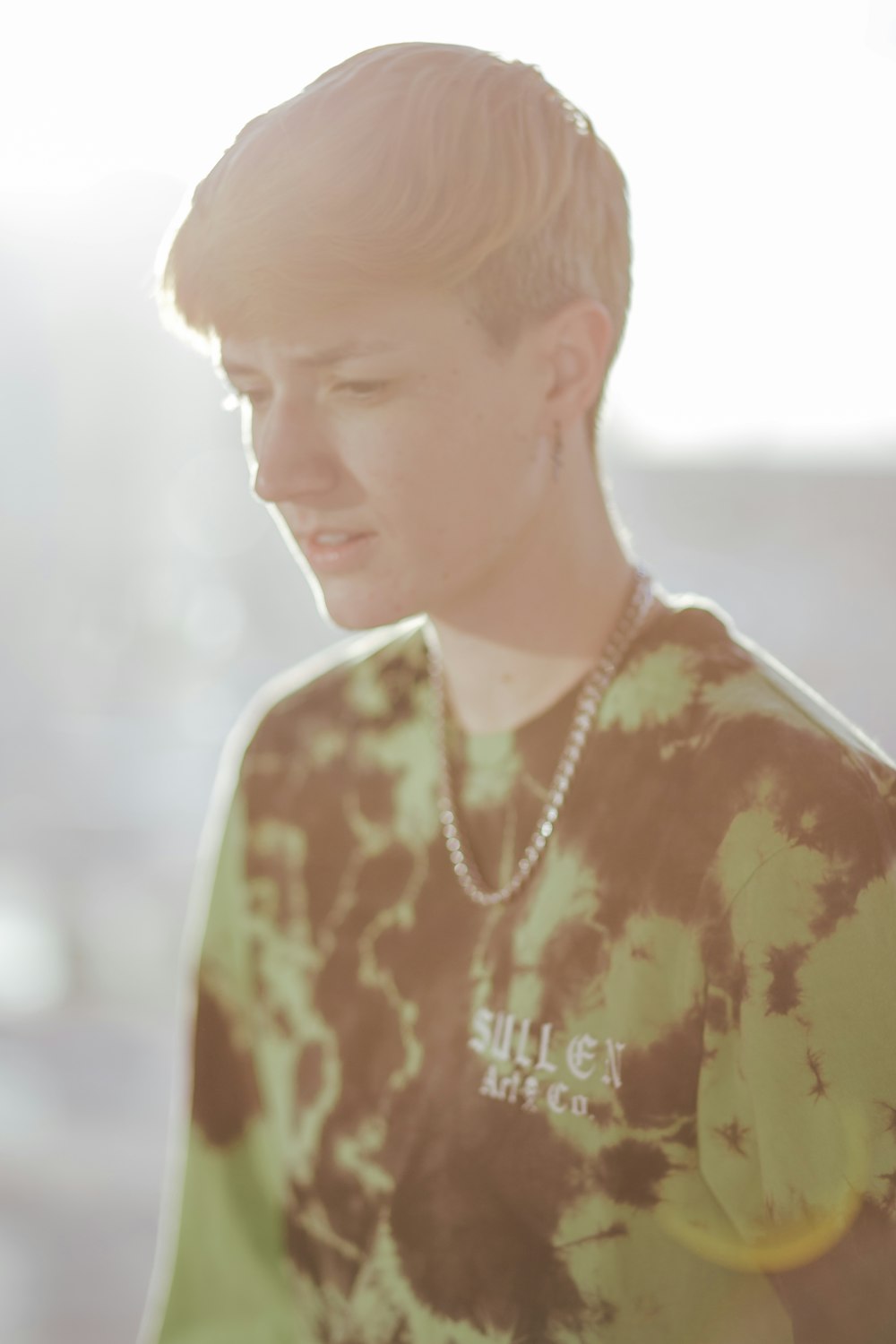 man in brown and white floral crew neck shirt