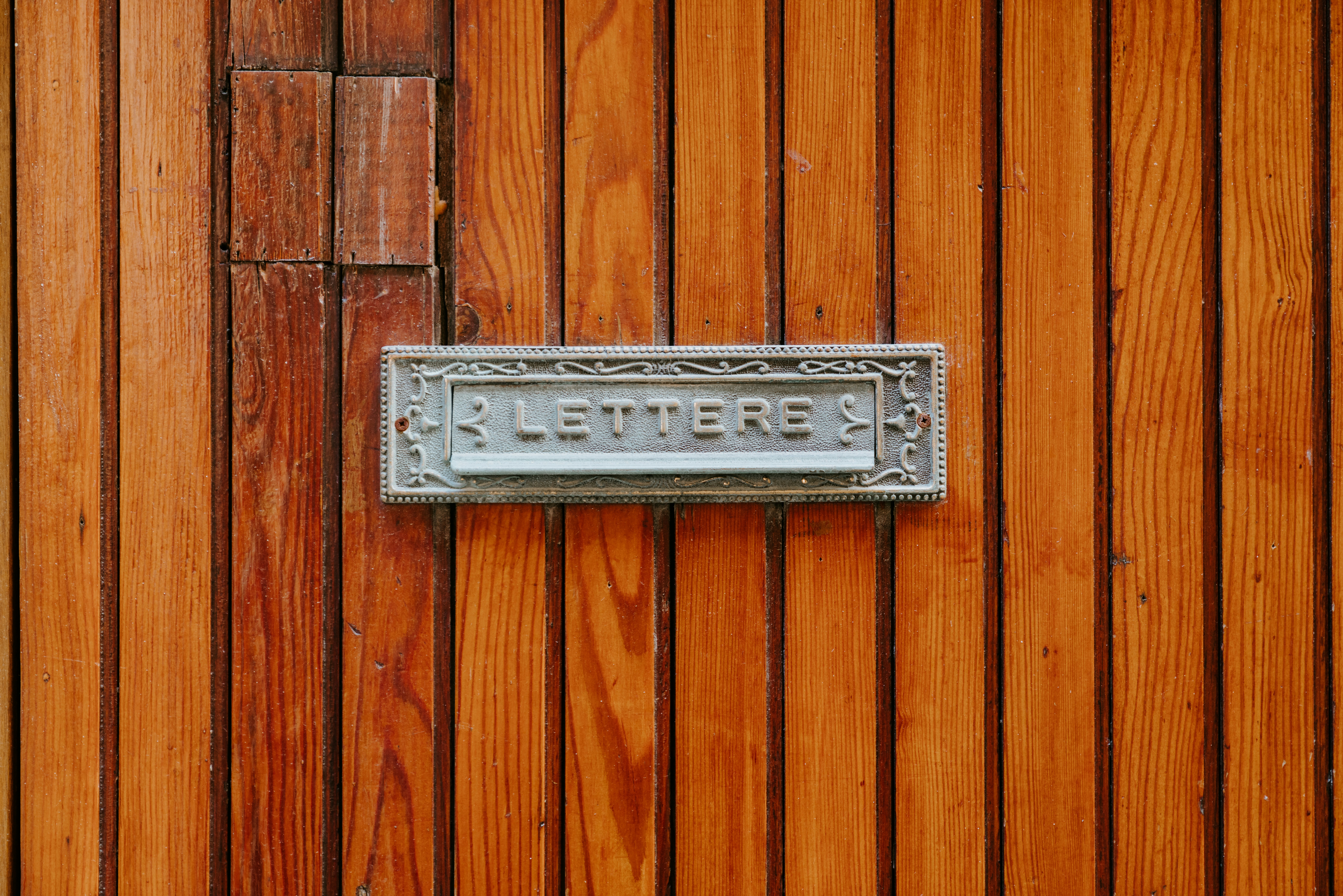 gray metal bar on brown wooden surface