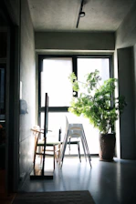 A cozy pod nestled in a sunlit urban loft with plants and minimalist decor.