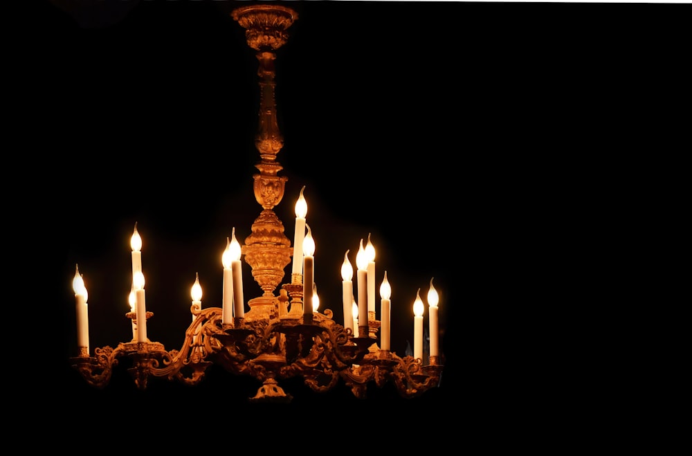 lighted candles on brown wooden stand