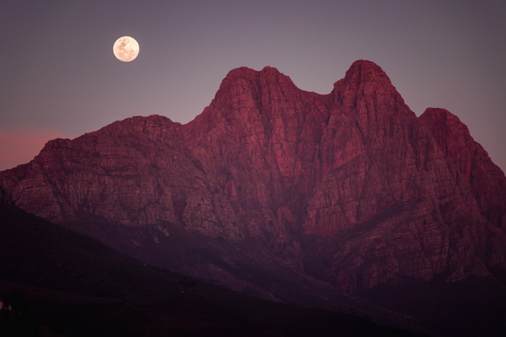 brown rocky mountain under full moon