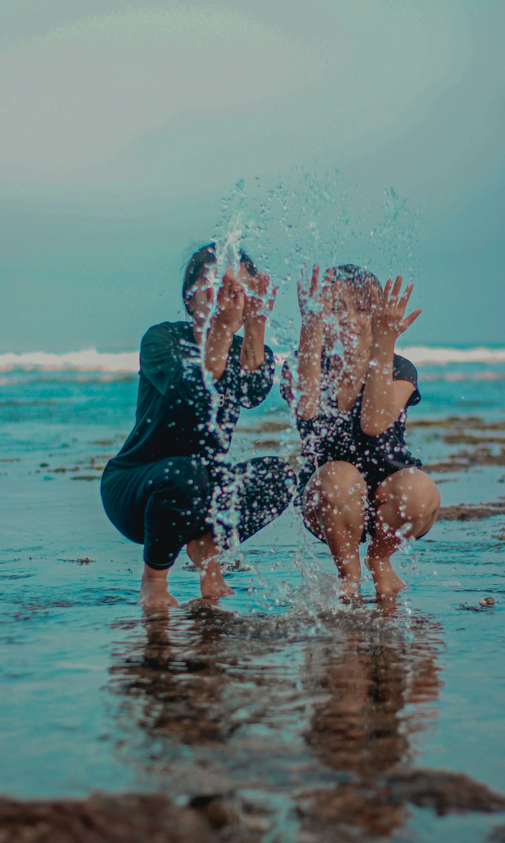 woman in black swimsuit playing with water