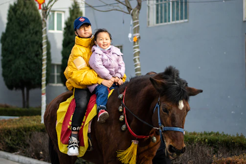 Children participating in an equestrian therapy session, building confidence.