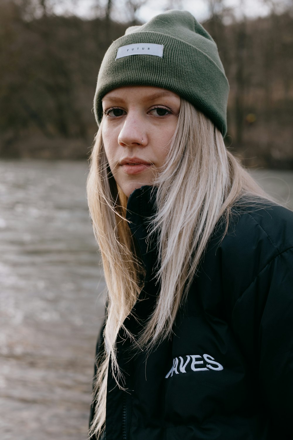 Mujer con abrigo negro y gorro de punto verde