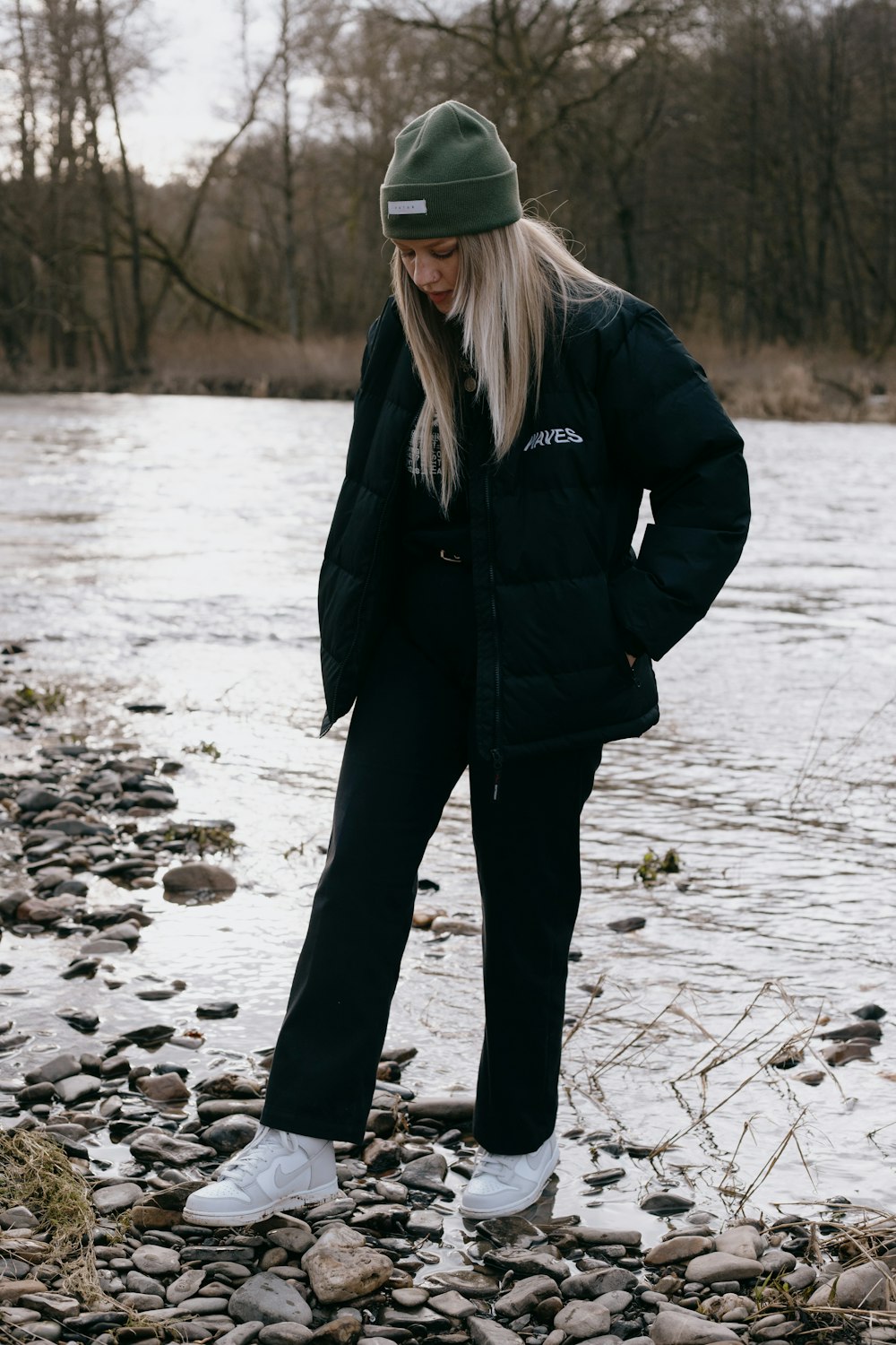 woman in black jacket standing on snow covered ground