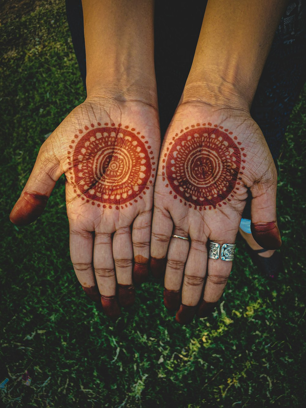 person with black and brown hand tattoo