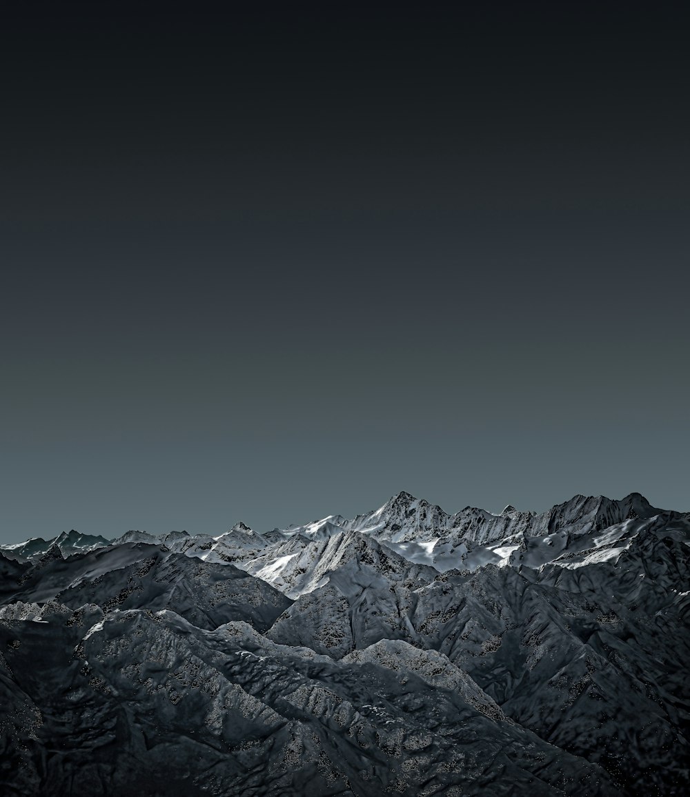 snow covered mountain under gray sky