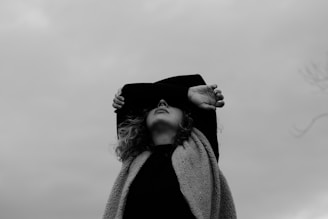 grayscale photo of woman in coat