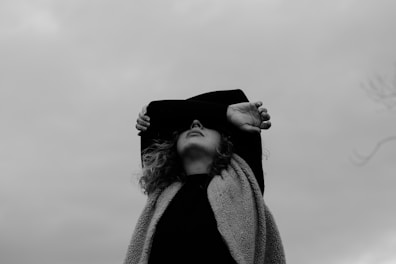 grayscale photo of woman in coat