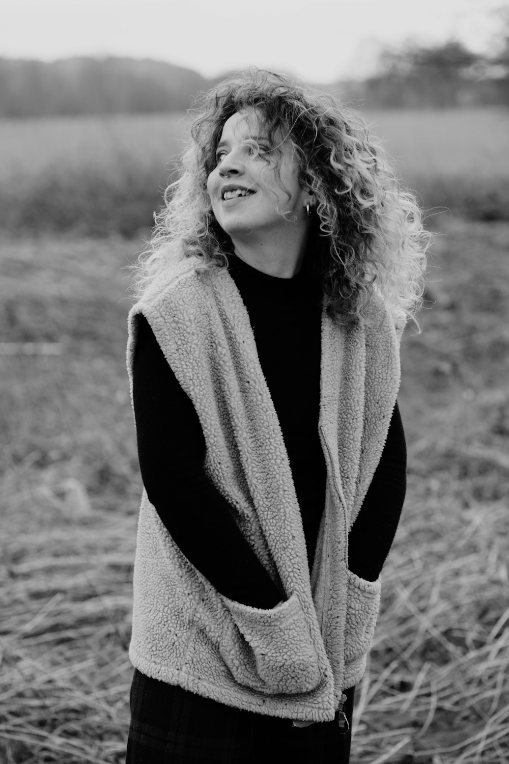 grayscale photo of woman in scarf and sweater