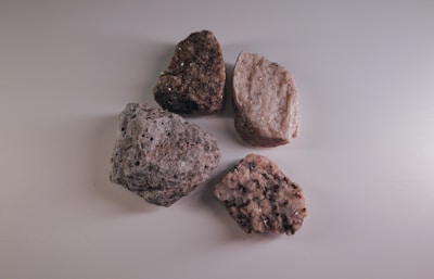 three brown stones on white surface