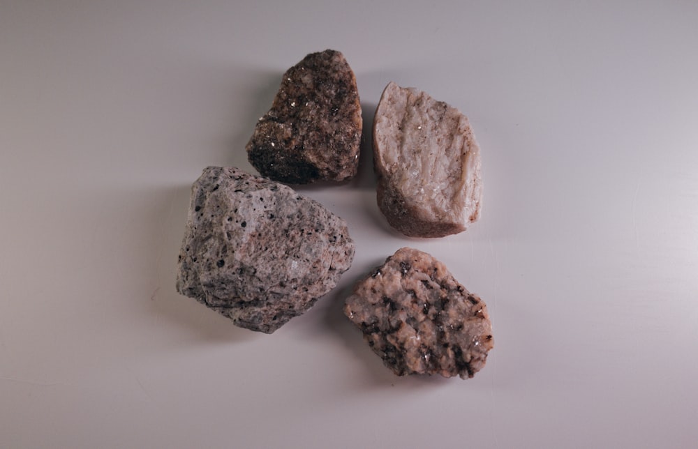 three brown stones on white surface