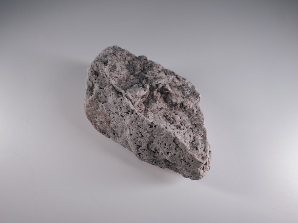 brown rock on white surface