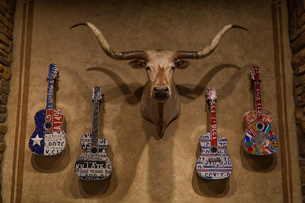 brown deer figurine beside white and black electric guitar