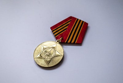 gold round coin on white table
