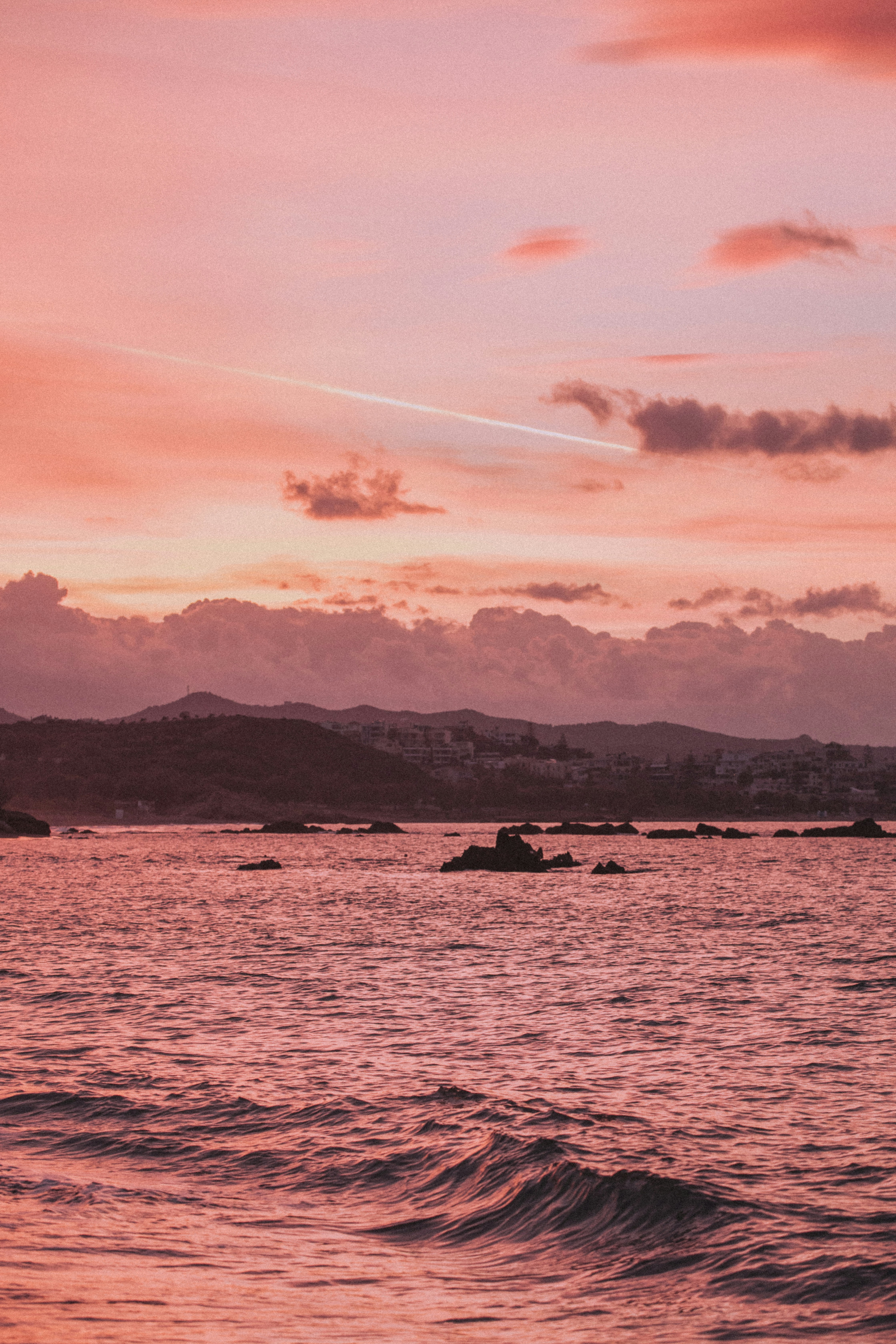 grayscale photo of sea and mountain
