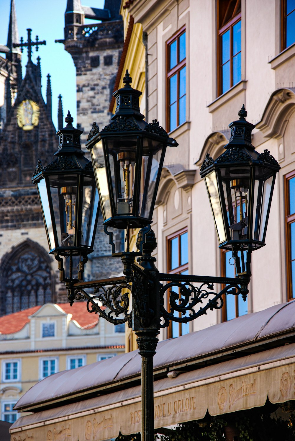 black metal sconce in front of white concrete building during daytime